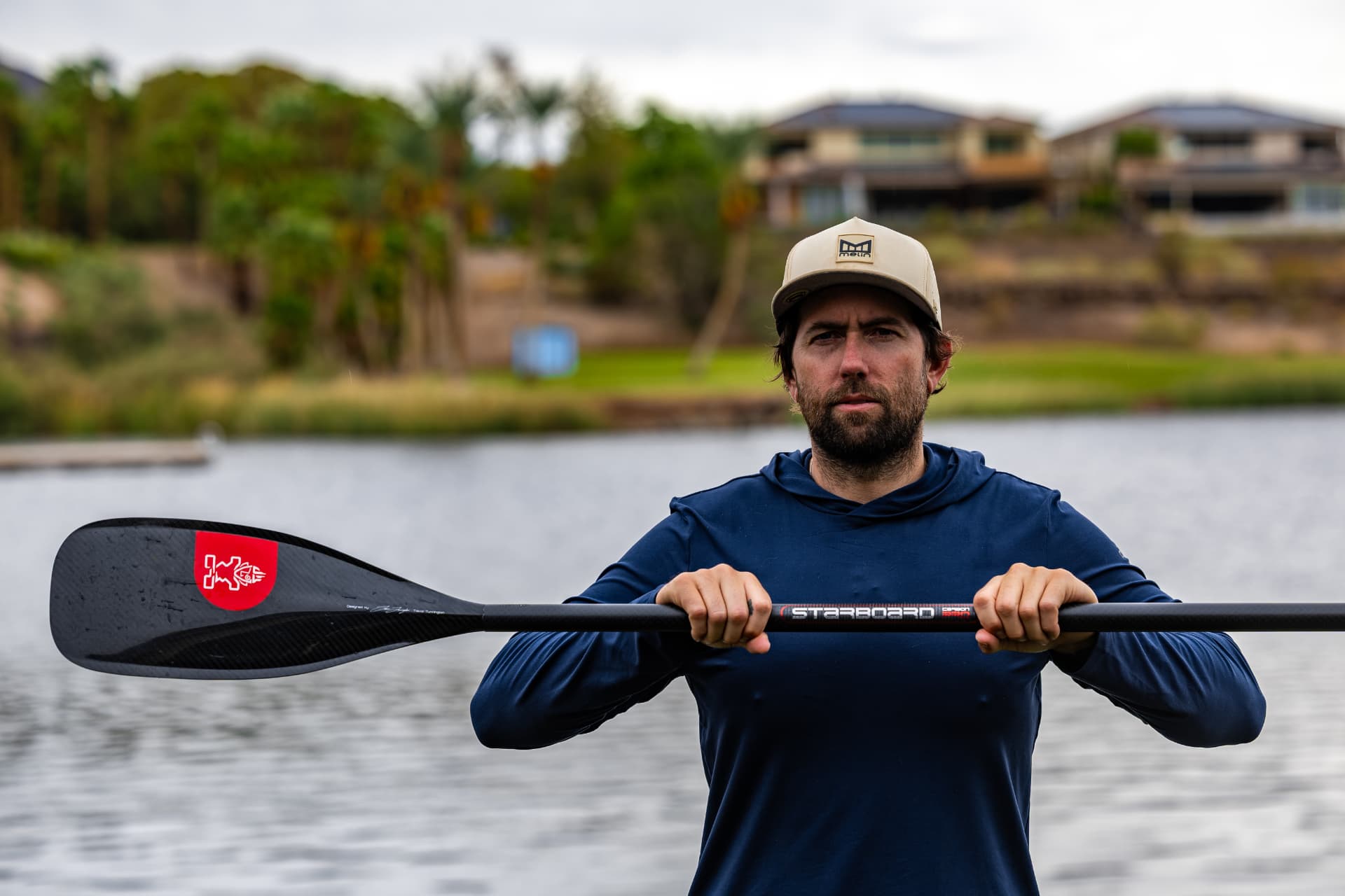 Paddler holding a Starboard carbon paddle on Lake Las Vegas